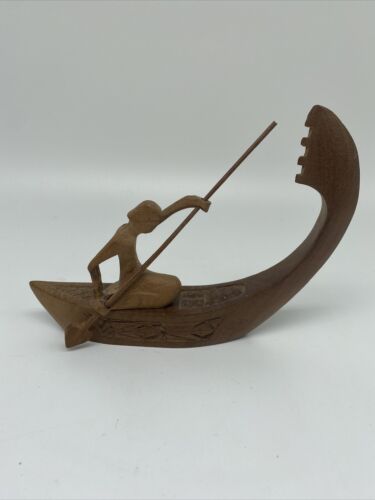 Vintage Native American Wood Carving Of Native American On Canoe Paddling.